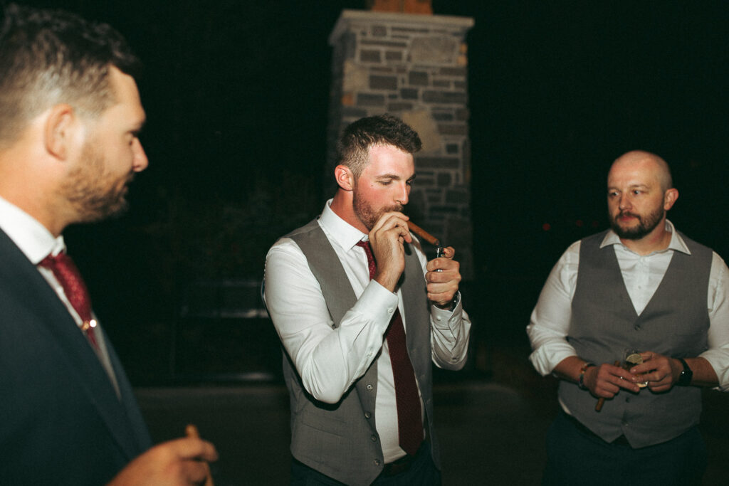 groomsmen lighting cigars