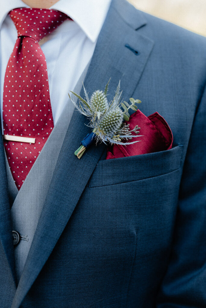 detail photo of wedding boutonniere on groom