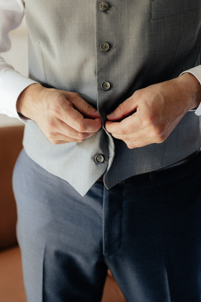 buttoning up a wedding suit