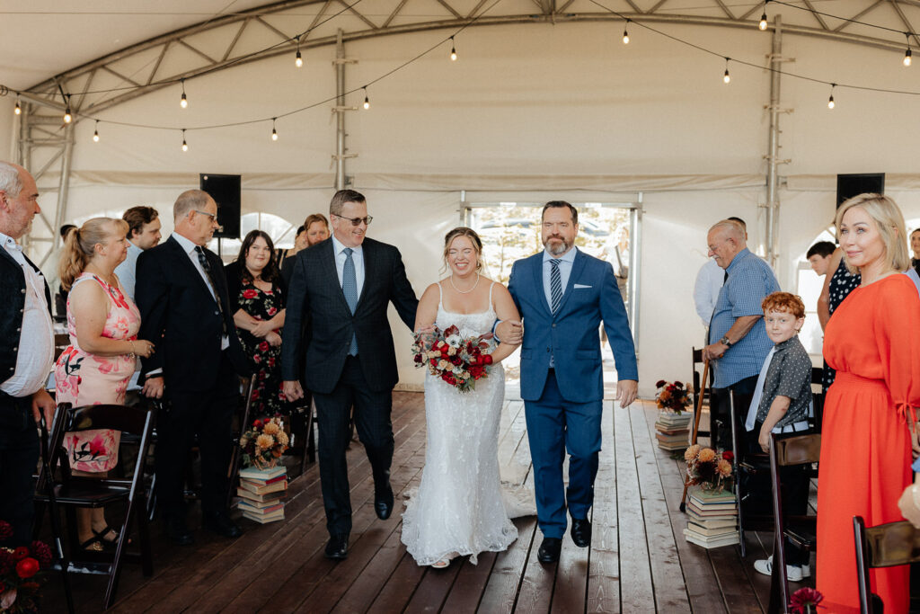 bride walking with her dads for a stewart creek wedding in canmore, alberta