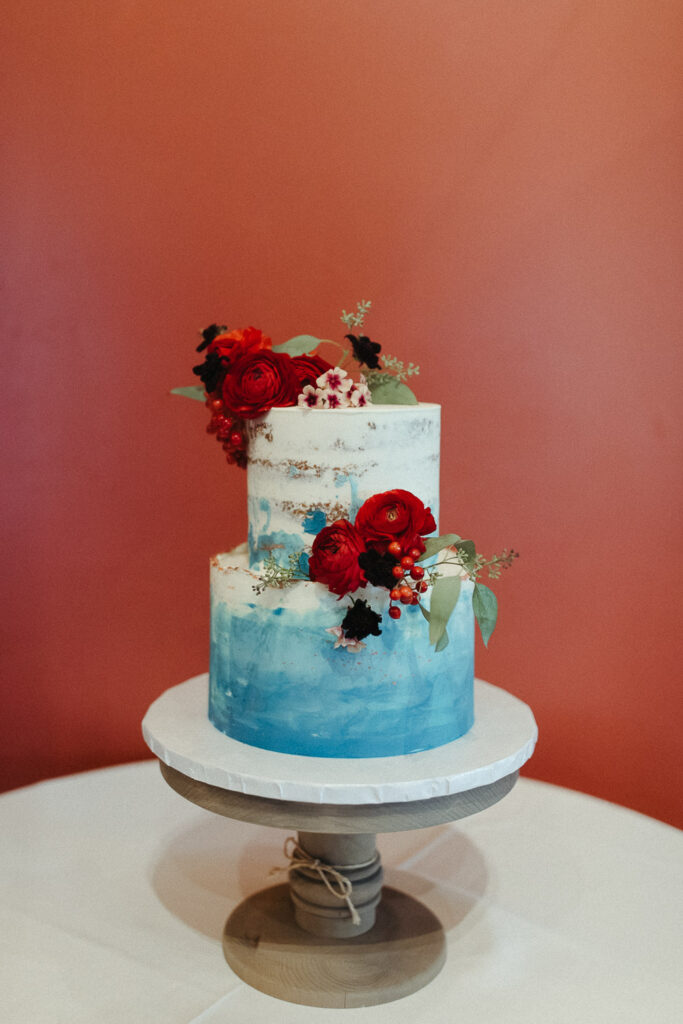 wedding cake with red flowers