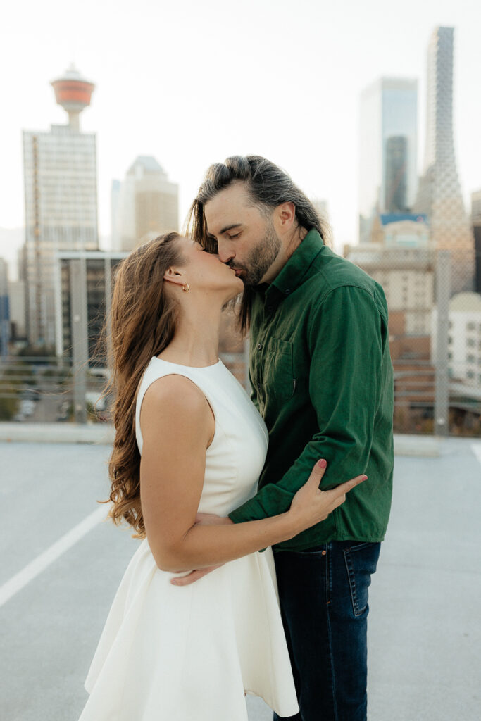 A couple kissing at their platform parkade engagement session